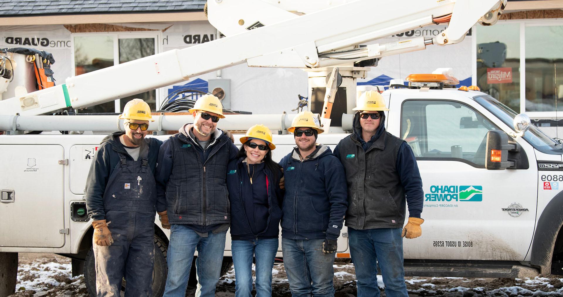 Image of Idaho Power employees in the field beside a truck